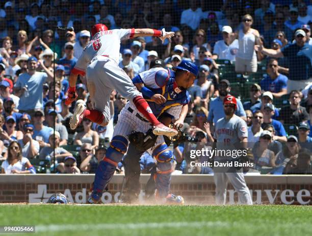 Billy Hamilton of the Cincinnati Reds is safe at home as Willson Contreras of the Chicago Cubs can't handle the throw during the fifth inning on July...