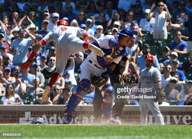 Billy Hamilton of the Cincinnati Reds is safe at home as Willson Contreras of the Chicago Cubs can't handle the throw during the fifth inning on July...