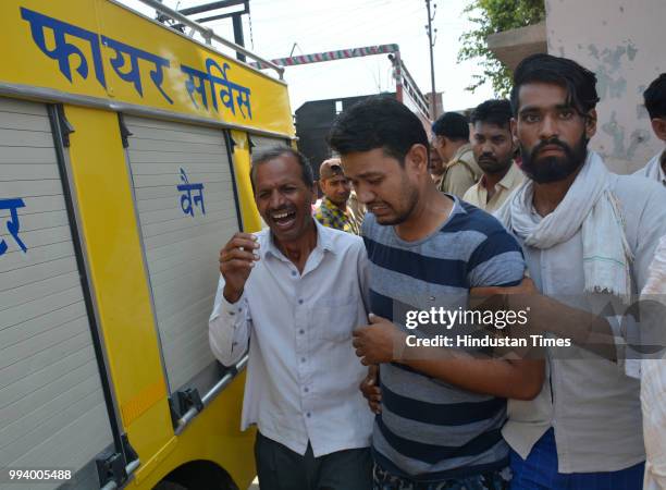 Family members and relatives of the victims seen at the spot where three men drowned in a sewage pumping station at Loni on July 8, 2018 in...