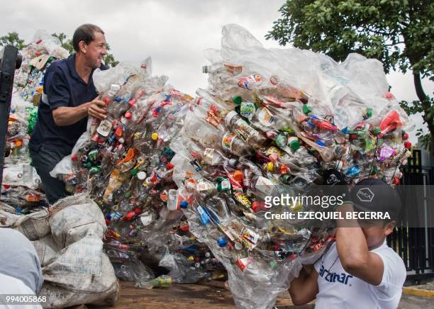 People help to collect 25 tons of plastic bottles for recycling, in eight hours, in order to set a Guinness World Record, in San Jose on July 8, 2018.