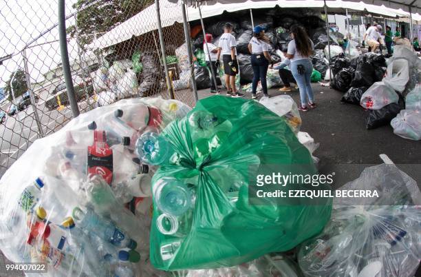 People help collect 25 tons of plastic bottles for recycling, in eight hours, in order to set a Guinness World Record, in San Jose on July 8, 2018.