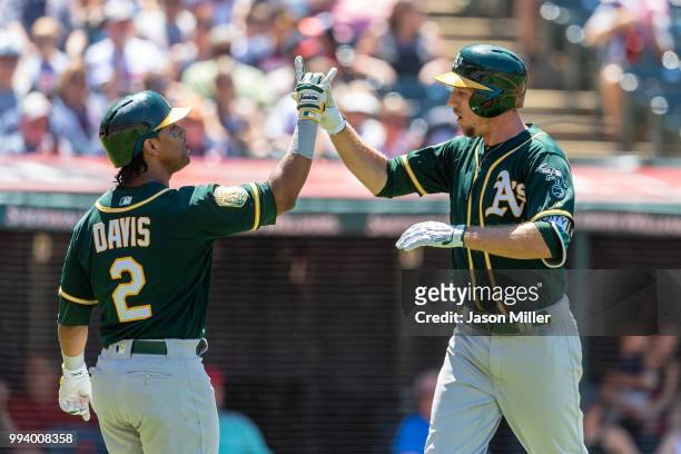 Khris Davis celebrates with Stephen Piscotty of the Oakland Athletics after both scored on a home run by Piscotty during the sixth inning against the...
