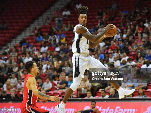 Lonnie Walker IV of the San Antonio Spurs catches a pass against Chris Chiozza of the Washington Wizards during the 2018 NBA Summer League at the...