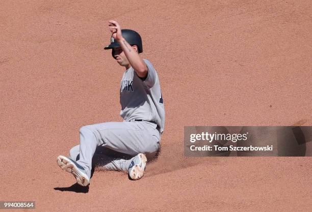 Pinch-runner Tyler Wade of the New York Yankees slides into second base as he advances safely on a sacrifice bunt by Austin Romine in the tenth...