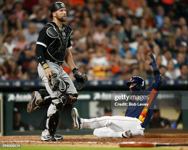 Yuli Gurriel of the Houston Astros scores on a sacrifice bunt by Marwin Gonzalez in the seventh inning as Kevan Smith of the Chicago White Sox looks...