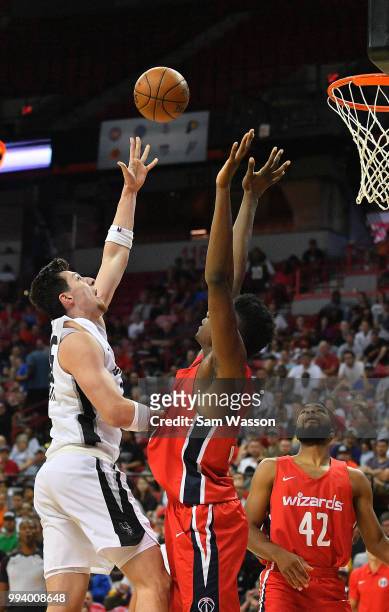 Drew Eubanks of the San Antonio Spurs shoots against Thomas Bryant and Aaron Harrison of the Washington Wizards during the 2018 NBA Summer League at...