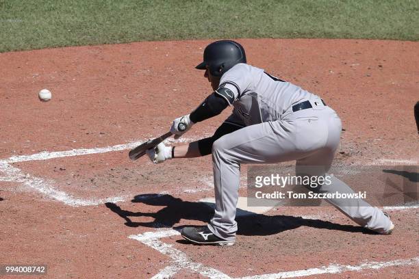 Austin Romine of the New York Yankees lays down a sacrifice bunt in the tenth inning during MLB game action against the Toronto Blue Jays at Rogers...