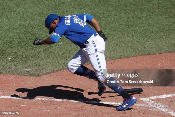 Curtis Granderson of the Toronto Blue Jays runs to first base after striking out in the tenth inning during MLB game action against the New York...