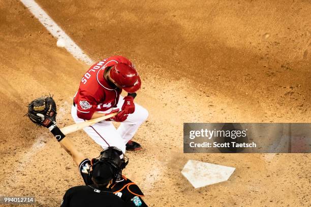 Wild pitch by Elieser Hernandez of the Miami Marlins , goes behind Mark Reynolds of the Washington Nationals during the inning at Nationals Park on...