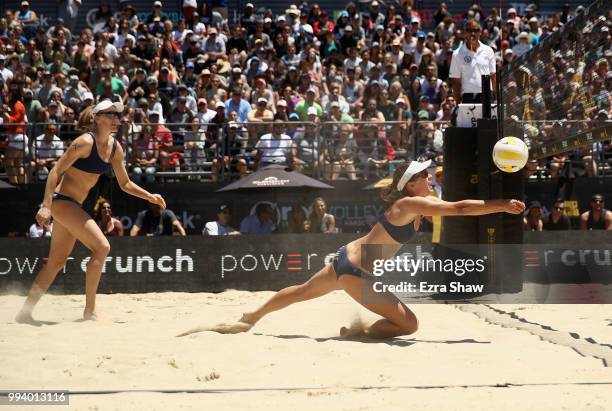 Betsi Flint dives for the ball as her partner Emily Day looks on during their semifinal match against Brittany Howard and Kelly Reeves of the AVP San...