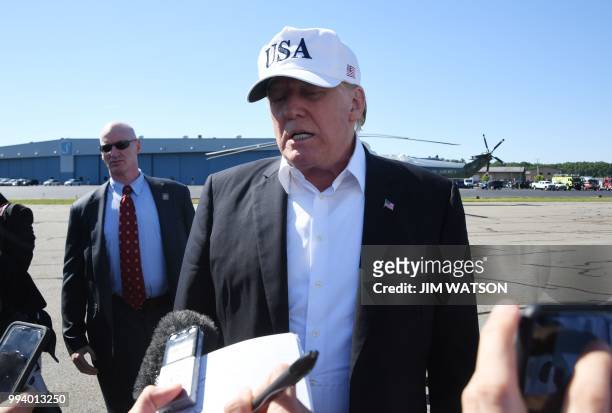 President Donald Trump confers with the media upon arrival at Morristown Municipal Airport in Morristown, New Jersey, July 8, 2018 prior to boarding...
