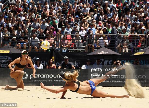 Kelly Reeves dives for the ball as her partner Brittany Howard looks on during their semifinal match against Emily Day and Betsi Flint at the AVP San...