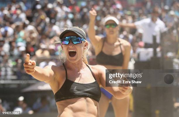 Kelly Reeves and Brittany Howard celebrate winning a point during their semifinal match against Emily Day and Betsi Flint at the AVP San Francisco...