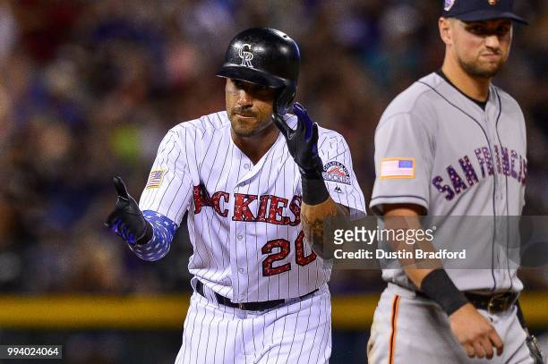 Ian Desmond of the Colorado Rockies celebrates after reaching second base on a run-scoring play against the San Francisco Giants at Coors Field on...