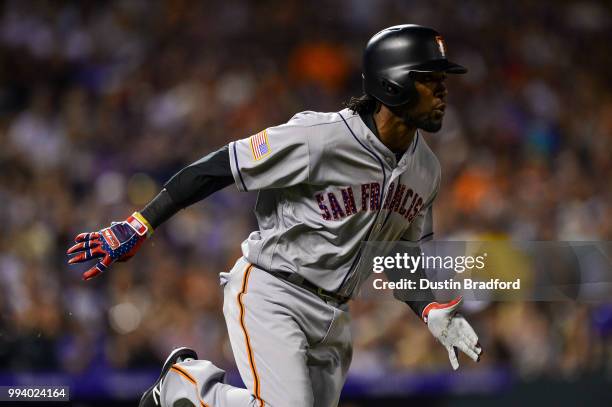 Alen Hanson of the San Francisco Giants runs out an eighth inning pinch hit single against the Colorado Rockies at Coors Field on July 2, 2018 in...