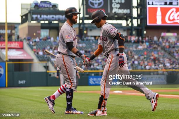 Gorkys Hernandez of the San Francisco Giants is congratulated by Brandon Belt after hitting a first inning leadoff homerun against the Colorado...