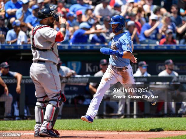 Kansas City Royals' Whit Merrifield scores behind Boston Red Sox catcher Sandy Leon on a two run double by Jorge Bonifacio in the third inning during...