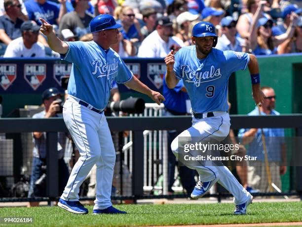 Kansas City Royals' Drew Butera is signaled home by third base coach Mike Jirschele on a two run double by Jorge Bonifacio in the third inning during...