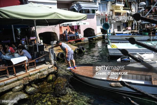 Fisherman docks his boat after fishing on July 8, 2018 on bosphorus river at Anadolu Kavagi, northern Istanbul.