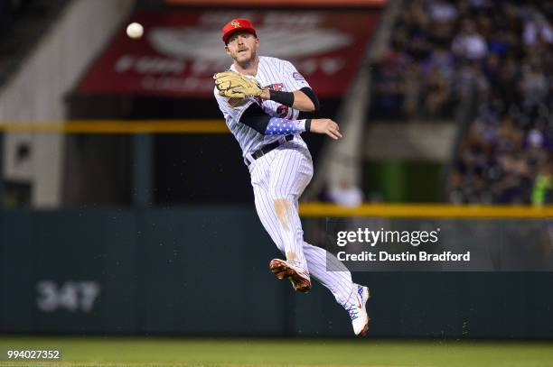 Trevor Story of the Colorado Rockies fields a ground ball against the San Francisco Giants at Coors Field on July 2, 2018 in Denver, Colorado.