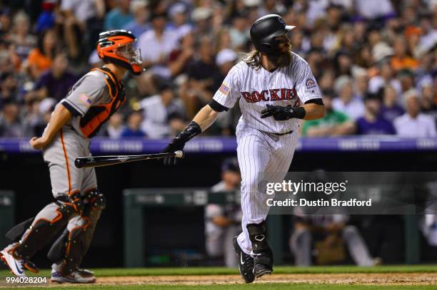 Charlie Blackmon of the Colorado Rockies watches the flight of an eighth inning RBI sacrifice fly against the San Francisco Giants at Coors Field on...