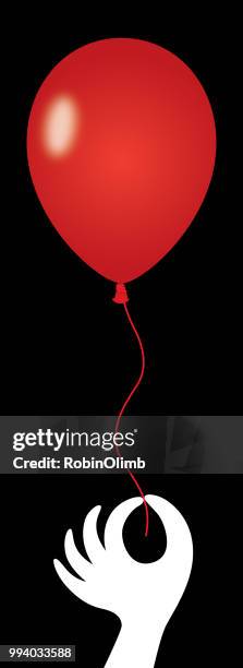 hand holding red red ballon - robinolimb stock illustrations