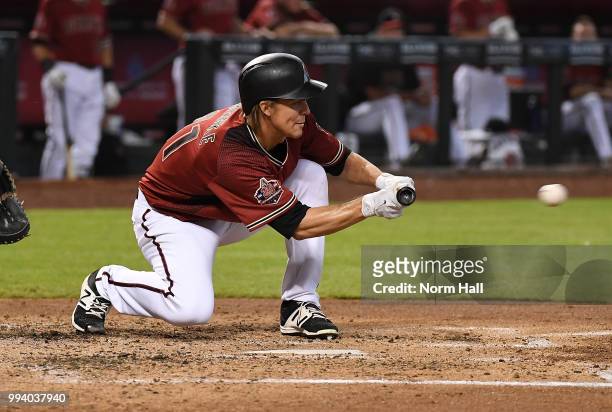 Zack Greinke of the Arizona Diamondbacks drops down a bunt during the third inning against the San Diego Padres at Chase Field on July 8, 2018 in...