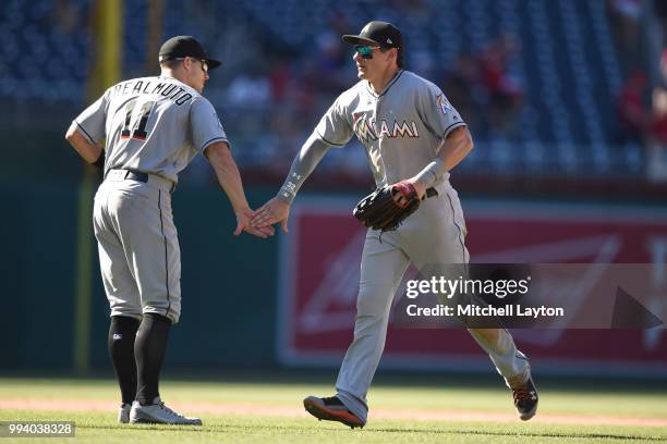 Derek Dietrich of the Miami Marlins celebrates a win with J.T. Realmuto after a baseball game against the Washington Nationals at Nationals Park on...