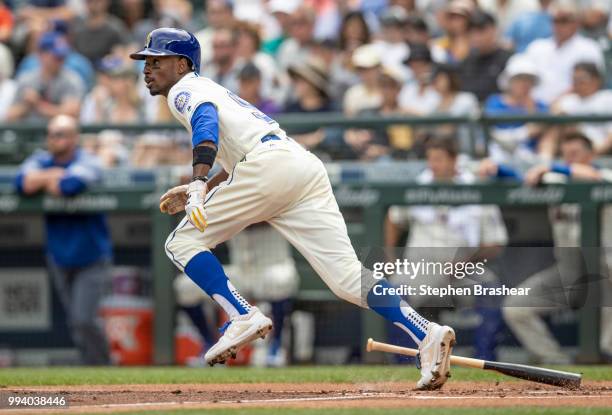 Dee Gordon of the Seattle Mariners hits a single off of starting pitcher Antonio Senzatela of the Colorado Rockies during the first inning of a game...