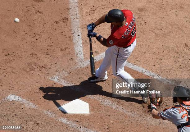 Eduardo Escobar of the Minnesota Twins hits a two-run home run as Caleb Joseph of the Baltimore Orioles catches during the sixth inning of the game...