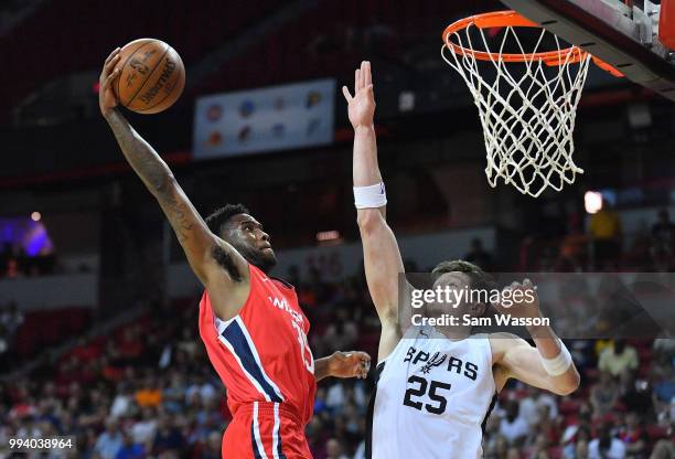 Tiwian Kendley of the Washington Wizards dunks against Drew Eubanks of the San Antonio Spurs during the 2018 NBA Summer League at the Thomas & Mack...