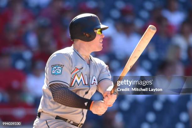 Justin Bour of the Miami Marlins doubles in two runs in the ninth inning during a baseball game against the Washington Nationals at Nationals Park on...