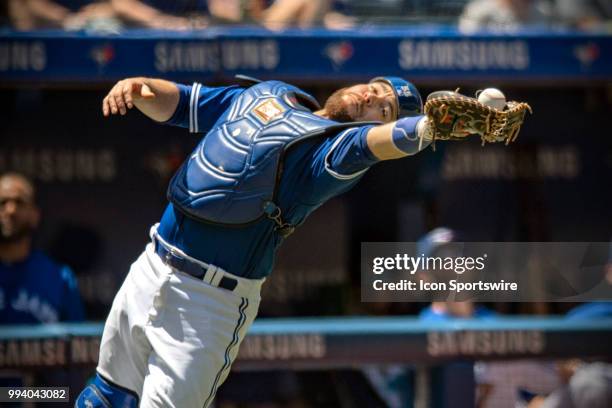 Toronto Blue Jays Catcher Russell Martin catches a pop fly during the MLB game between the New York Yankees and the Toronto Blue Jays on July 08,...