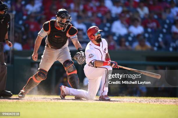 Adam Eaton of the Washington Nationals reacts after striking out and being tagged by J.T. Realmuto of the Miami Marlins in the eight inning during a...