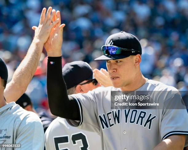 New York Yankees Outfielder Aaron Judge is congratulated by a teammate after the game between the New York Yankees and the Toronto Blue Jays on July...