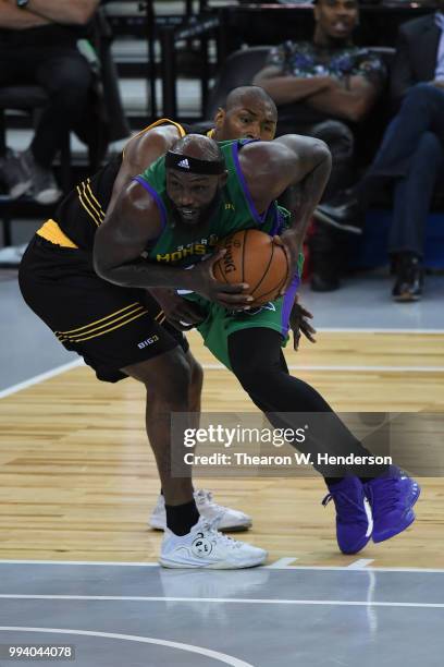 Reggie Evans of 3 Headed Monsters drives with the ball against Metta World Peace of Killer 3s during week three of the BIG3 three on three basketball...