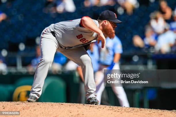Craig Kimbrel of the Boston Red Sox checks the sign before the pitch during the ninth inning against the Kansas City Royals at Kauffman Stadium on...