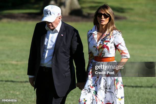 President Donald Trump and first lady Melania Trump cross the South Lawn upon arrival at the White House on July 8, 2018 in Washington, DC. The First...