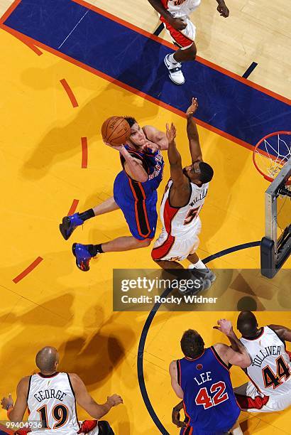 Danilo Gallinari of the New York Knicks goes up for a shot against Reggie Williams of the Golden State Warriors during the game at Oracle Arena on...