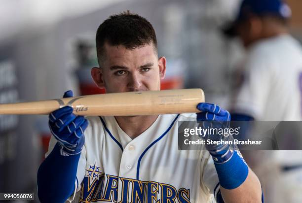 Ryon Healy of the Seattle Mariners holds up teammate Mitch Haniger's bat after Healy hit a three-run home run off of starting pitcher Antonio...