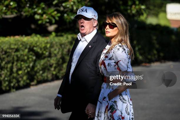 President Donald Trump and first lady Melania Trump cross the South Lawn upon arrival at the White House on July 8, 2018 in Washington, DC. The First...
