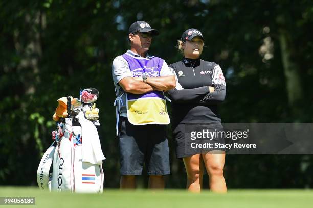 Ariya Jutanugarn of Thailand speaks with her caddie on the first hole during the final round of the Thornberry Creek LPGA Classic at Thornberry Creek...