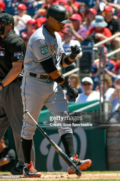 Miami Marlins second baseman Starlin Castro tosses his bat after striking out to end the first inning during the game between the Miami Marlins and...