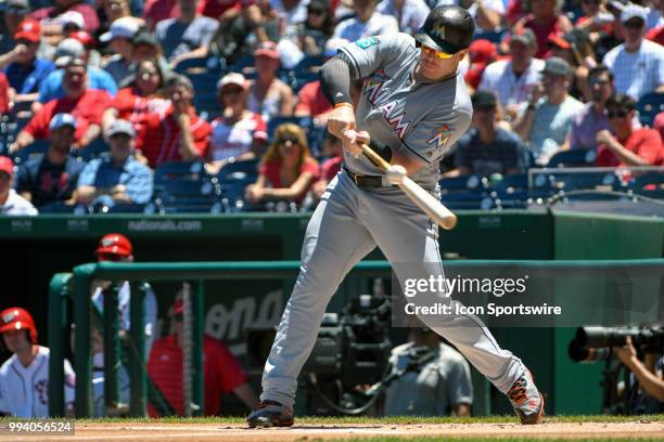 Miami Marlins first baseman Justin Bour hits an infield single in the first inning during the game between the Miami Marlins and the Washington...