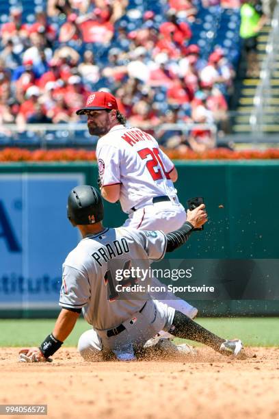 Miami Marlins third baseman Martin Prado goes into second base and prevents Washington Nationals second baseman Daniel Murphy from completing a...