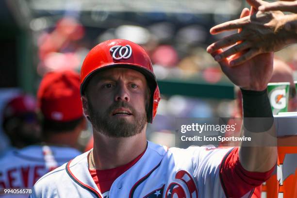 Washington Nationals third baseman Mark Reynolds is congratulated in the dugout after scoring during the game between the Miami Marlins and the...