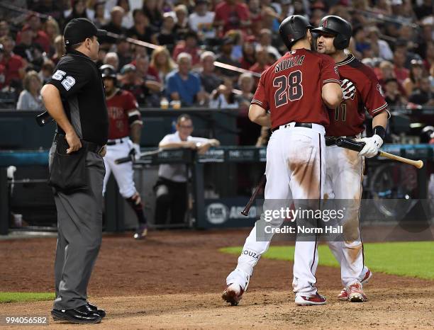 Pollock of the Arizona Diamondbacks is being held back by teammate Steven Souza Jr after being ejected for arguing balls and strikes with home plate...