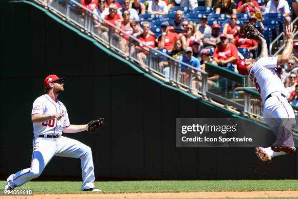 Washington Nationals first baseman Matt Adams leaps to catch a soft line drive as second baseman Daniel Murphy looses the ball in the sun during the...