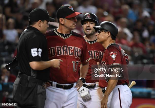 Pollock of the Arizona Diamondbacks is being held back by third base coach Tony Perezchica after being ejected for arguing balls and strikes as...