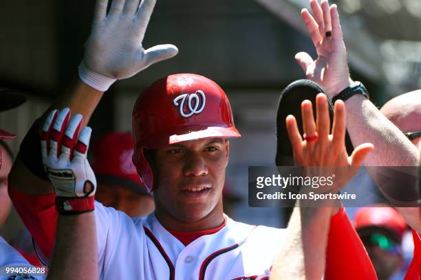 Washington Nationals left fielder Juan Soto is congratulated in the dugout after scoring during the game between the Miami Marlins and the Washington...